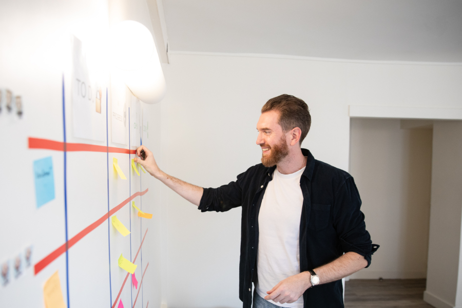 Sébastien Lonjon sticks a post-it on a board